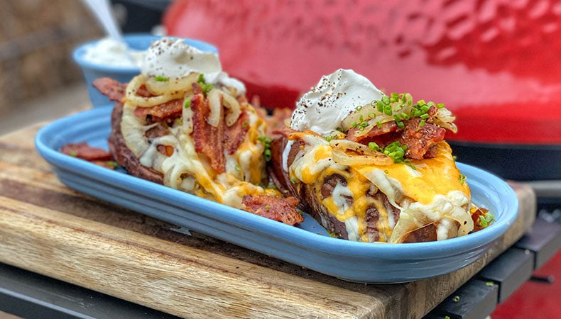 Dirty Loaded Sweet Potatoes sit in an oval plate ready for serving