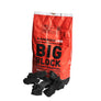 A bag of Kamado Joe Big Block SL Lump charcoal standing behind a small pile of lumps of charcoal