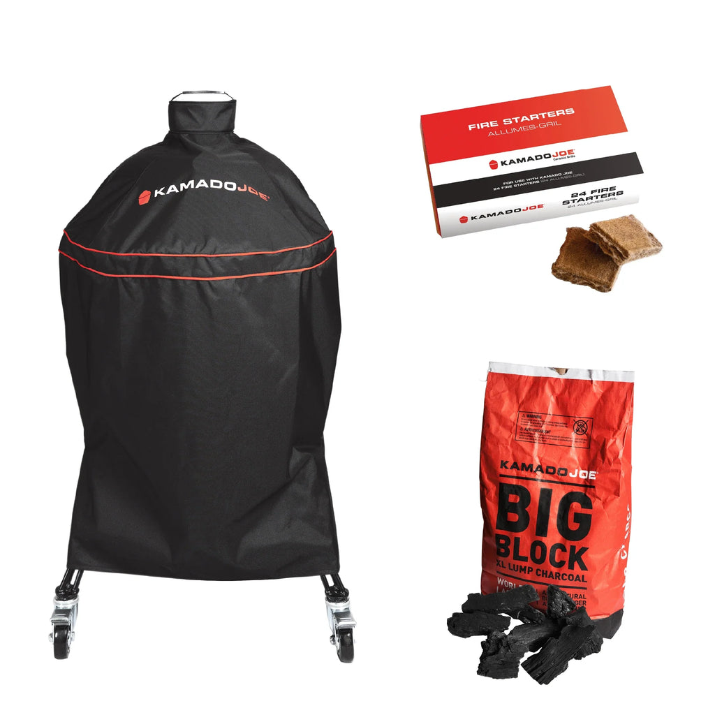 Kamado Joe black grill cover with red trim and logo, shown with a box of fire starters, two fire starters, and a bag of Kamado Joe Big Block charcoal on a white background.