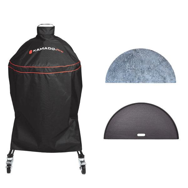 Black Kamado Joe grill cover with red piping and logo, shown with two included accessories: a half-moon soapstone and a half-moon cast iron reversible griddle, on a white background.