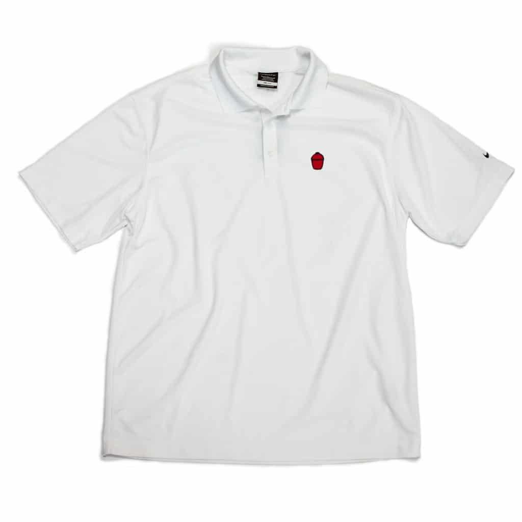 White golf shirt with red and black Kamado Joe grill logo on left breast and black Nike swoosh on left sleeve.