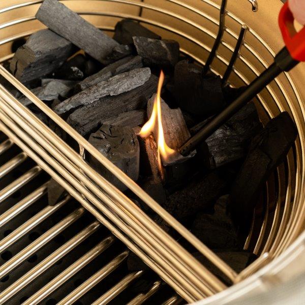 Lighting charcoal in one side of the divided basket