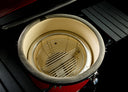 Interior of the grill showing the multi-piece firebox and divided charcoal basket.