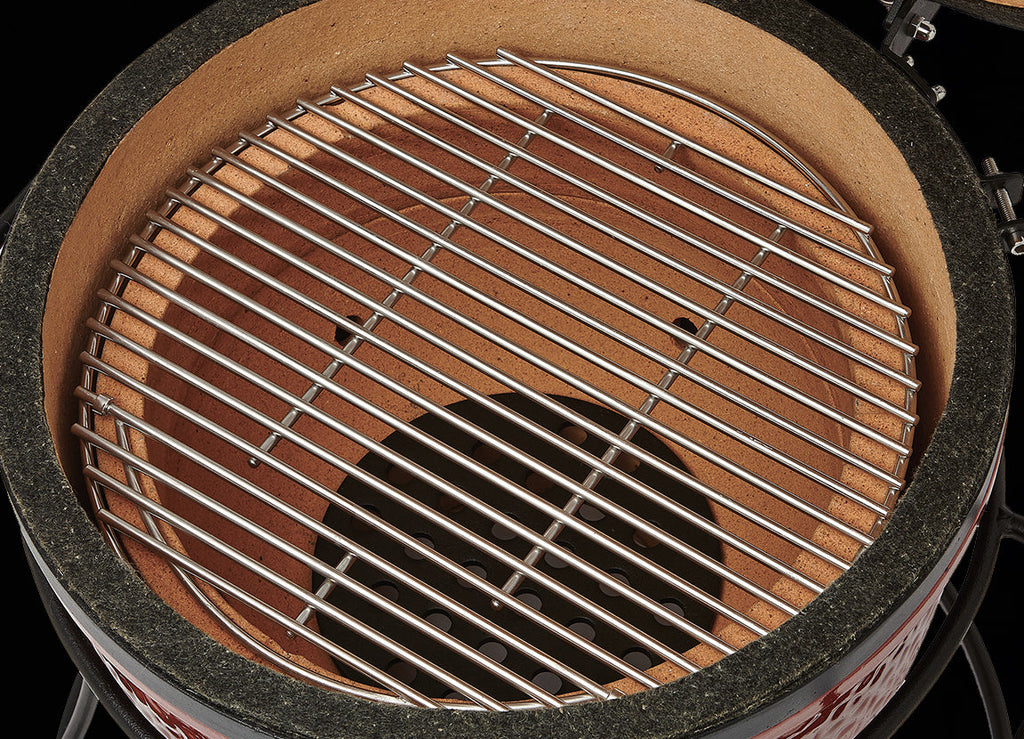 Interior of the grill showing the firebox, grill grate, and felt gasket around the top of the grill bottom.