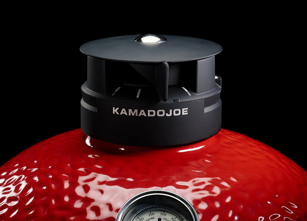 Close-up of the adjustable Kontrol Tower top vent at the top of the grill dome. The vent has a sliding adjustment shown open to position 3 of 4. Kamado Joe is printed in silver on the base of the vent.